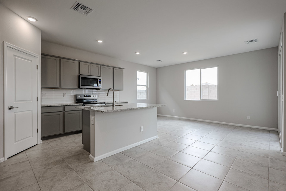 A kitchen with white cabinets.