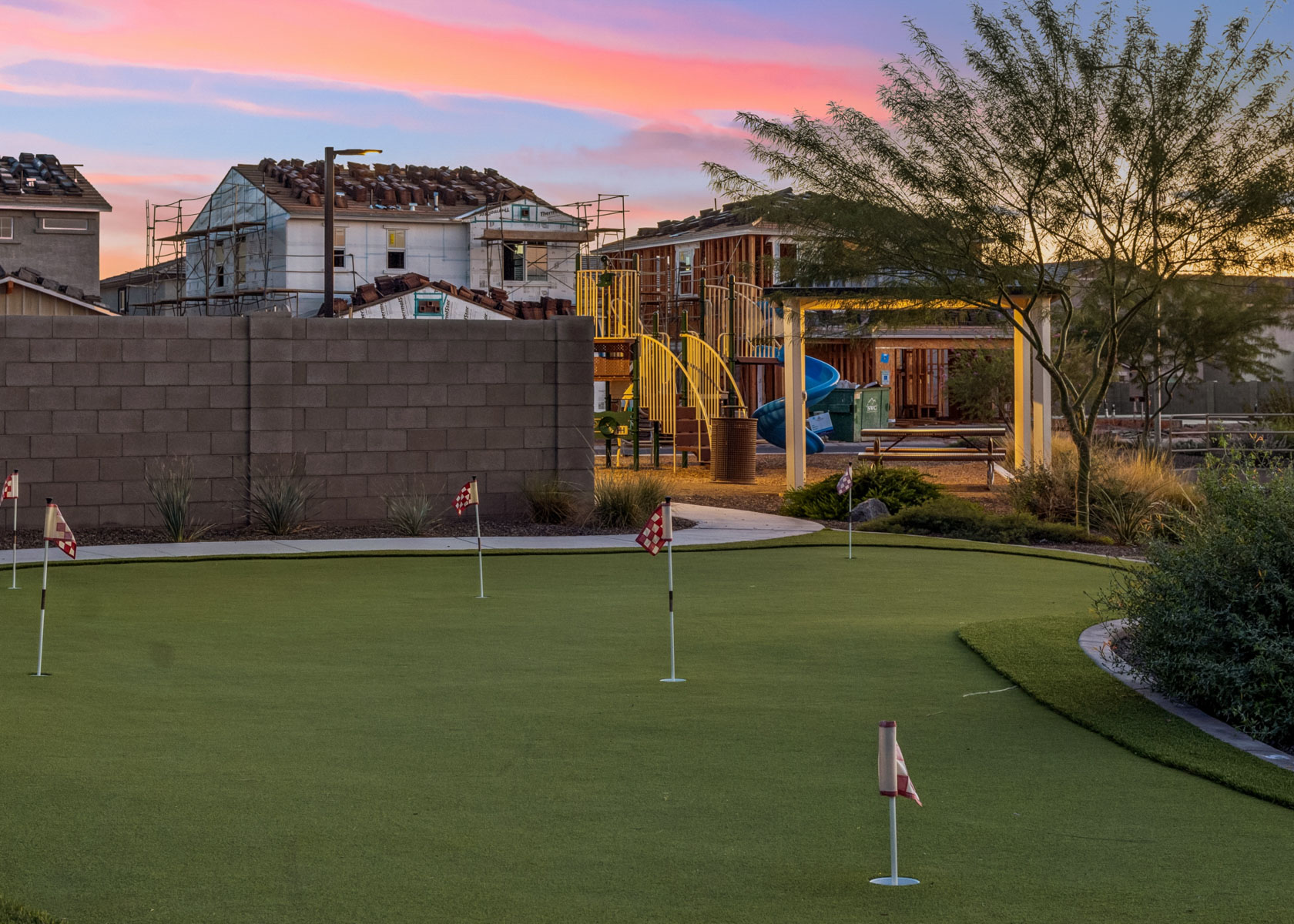 A golf course with a building in the background.