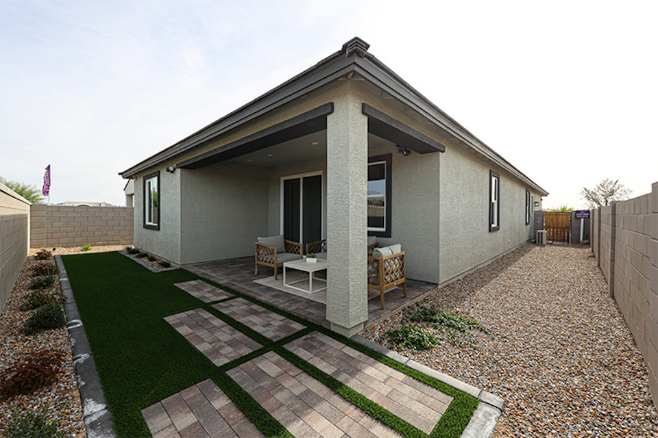 A house with a patio and a table and chairs.