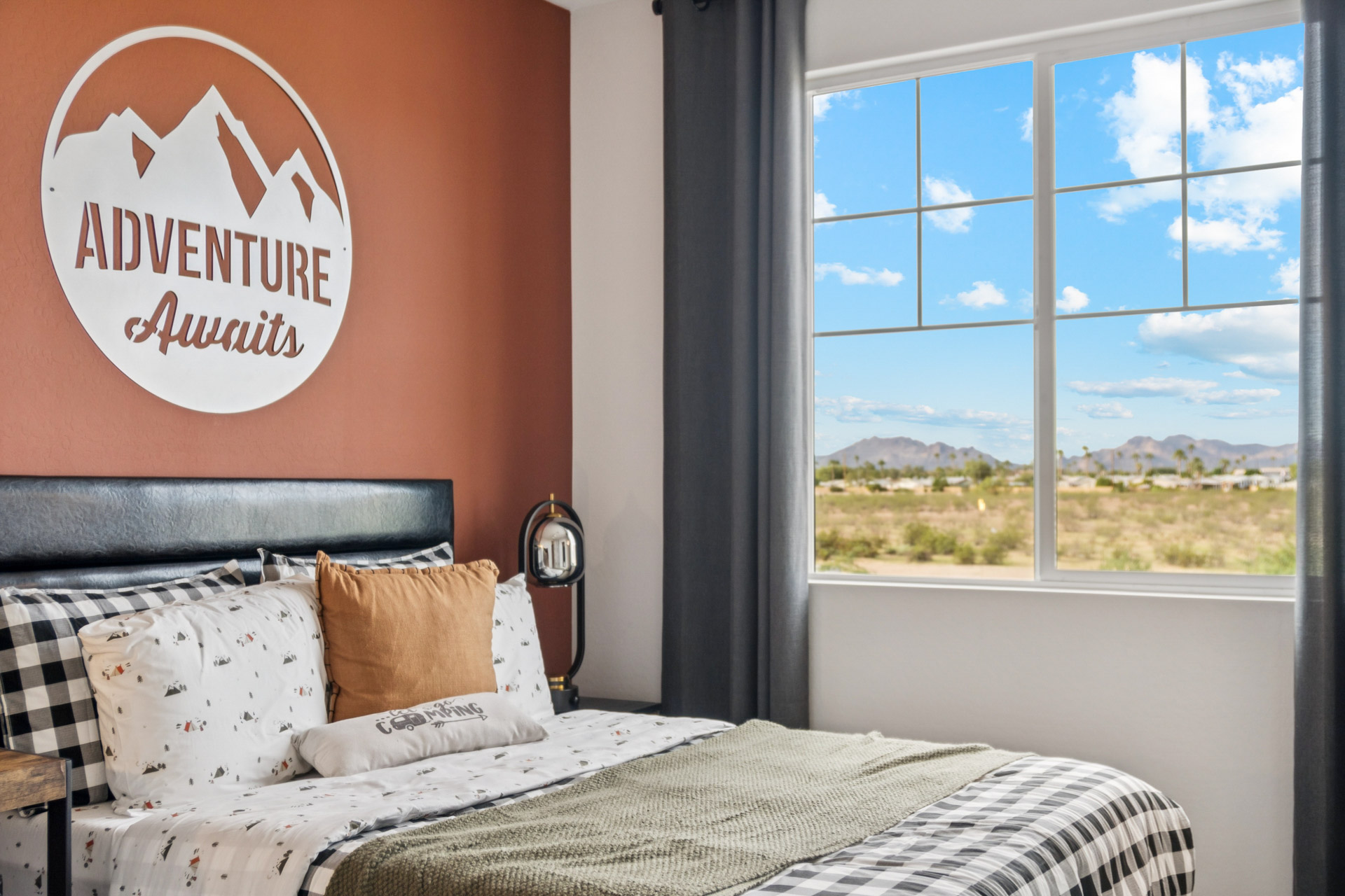 A bed with pillows and a lamp.