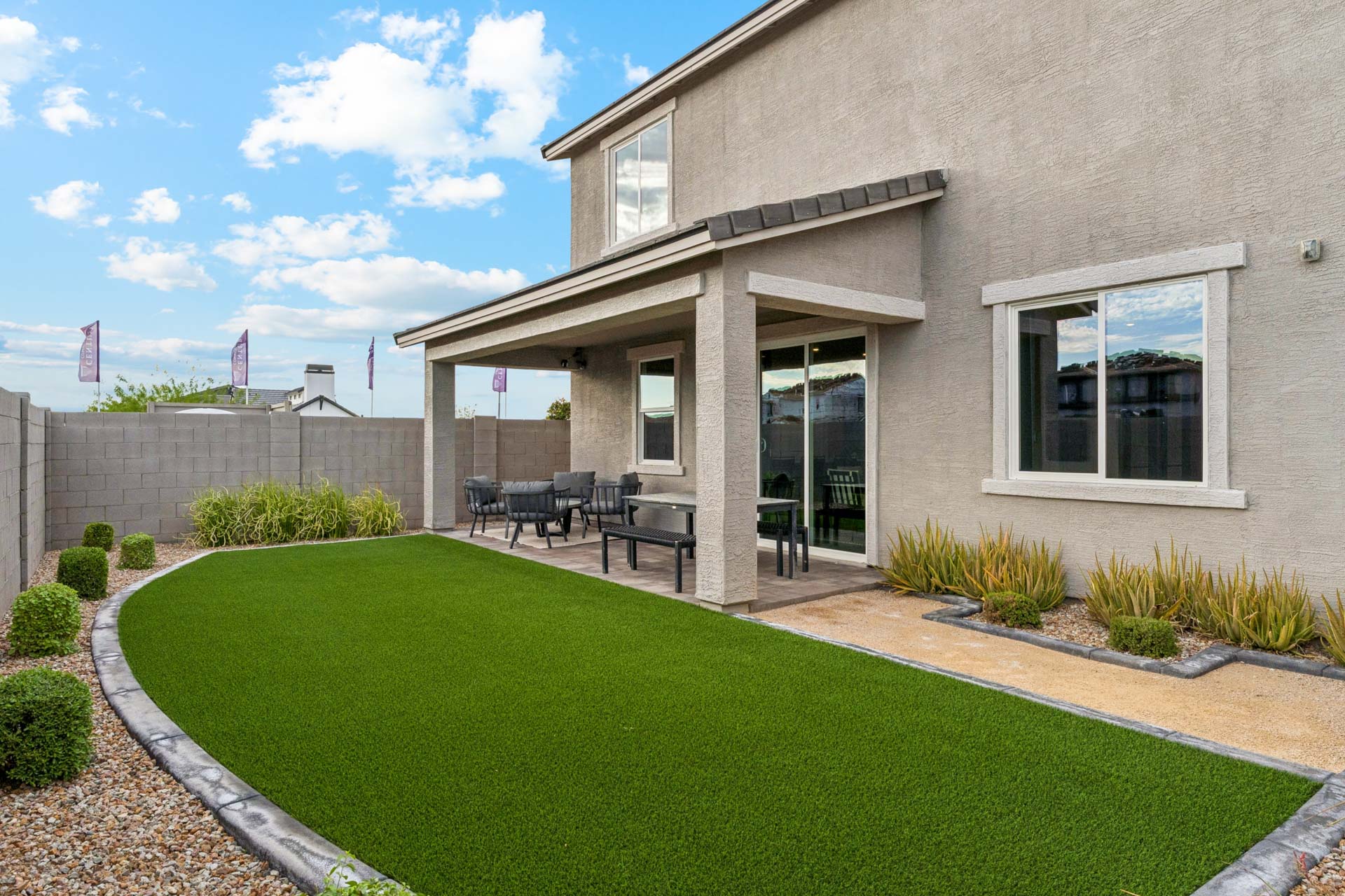 A building with a lawn and chairs.