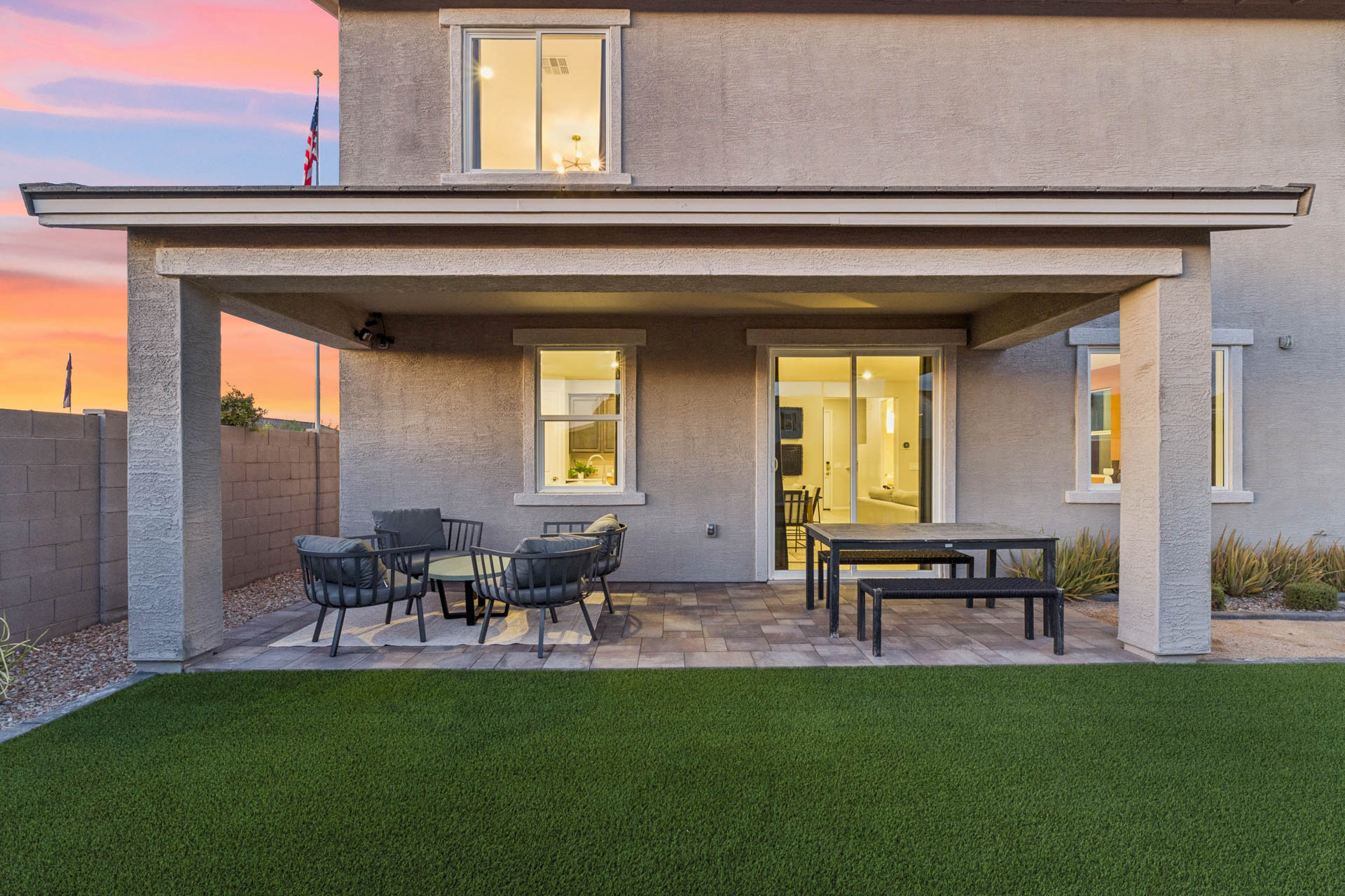 A patio with tables and chairs outside a building.