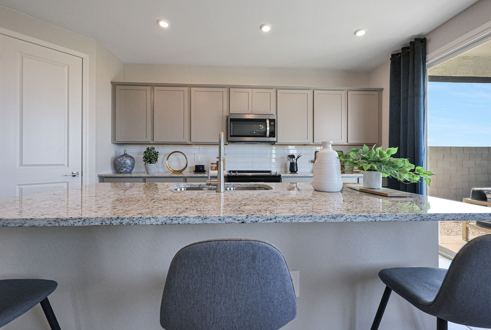 A kitchen with a marble countertop.