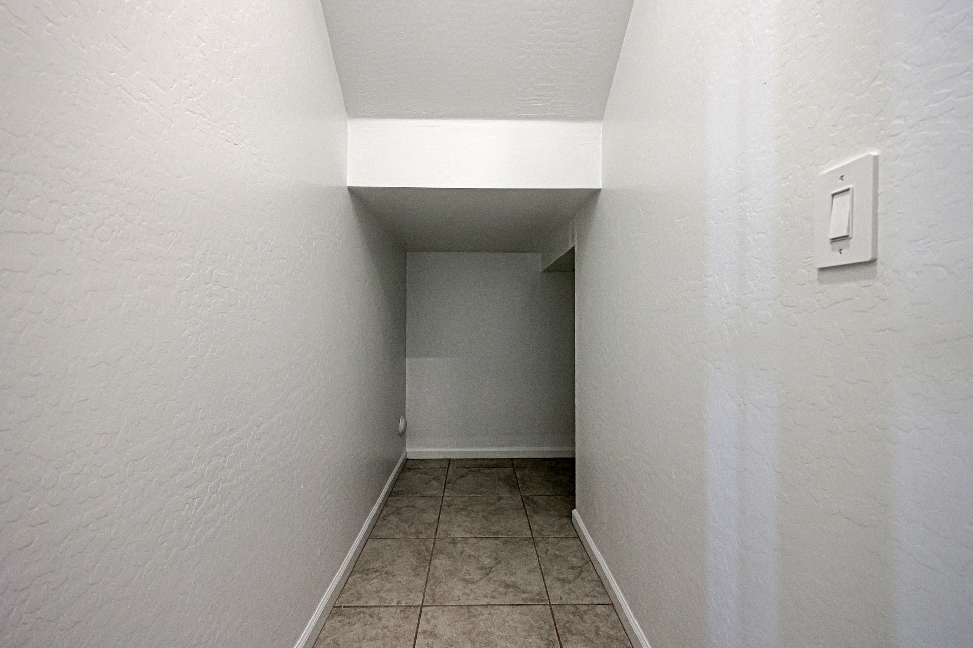 A hallway with white walls.