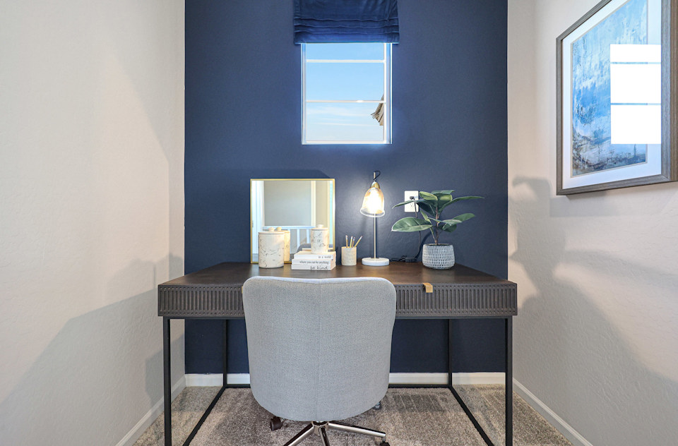 A desk with a chair and a window.