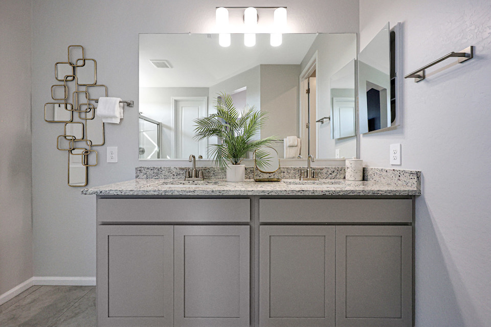 A bathroom with a large mirror.