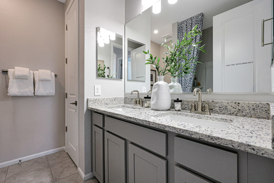 A bathroom with a marble countertop.