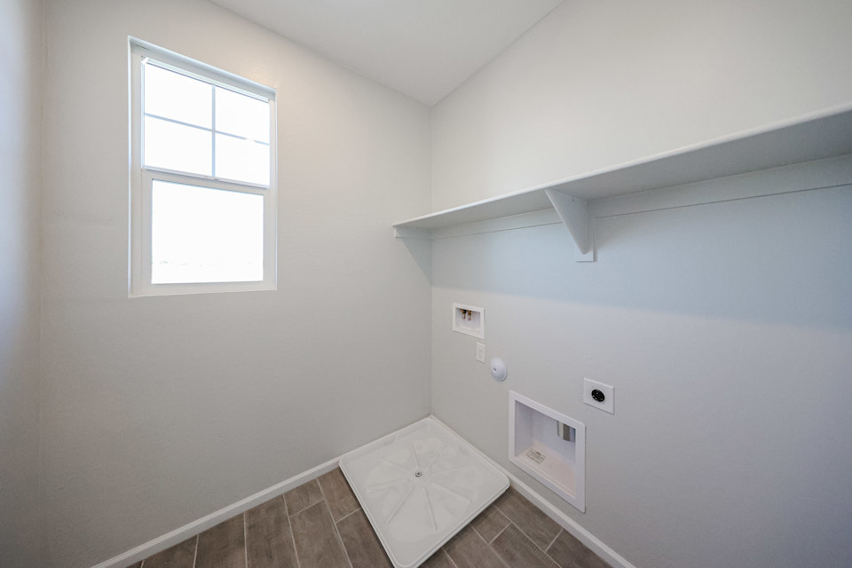 A room with a tile floor and a window.