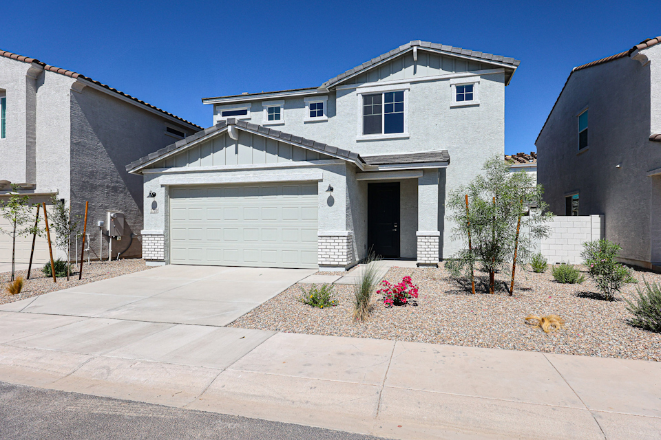 A house with garages and a driveway.