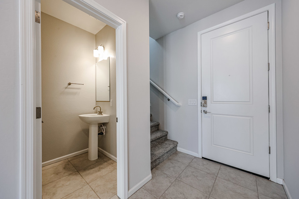 A bathroom with a sink and a mirror.