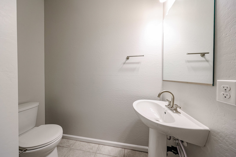 A bathroom with a sink and toilet.