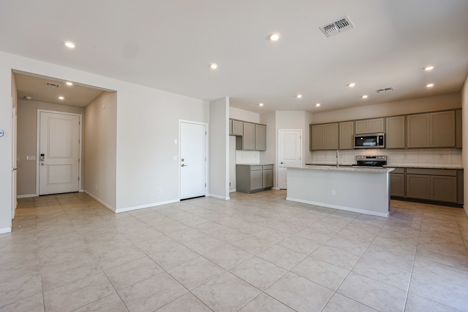 A kitchen with white cabinets.