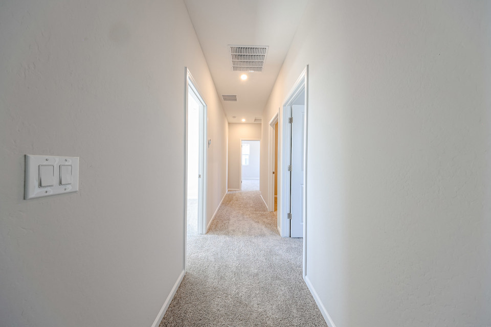 A hallway with white walls.