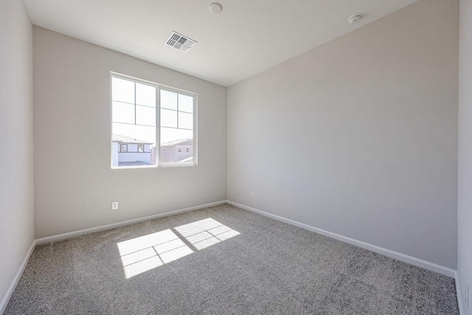 A room with a window and a tile floor.