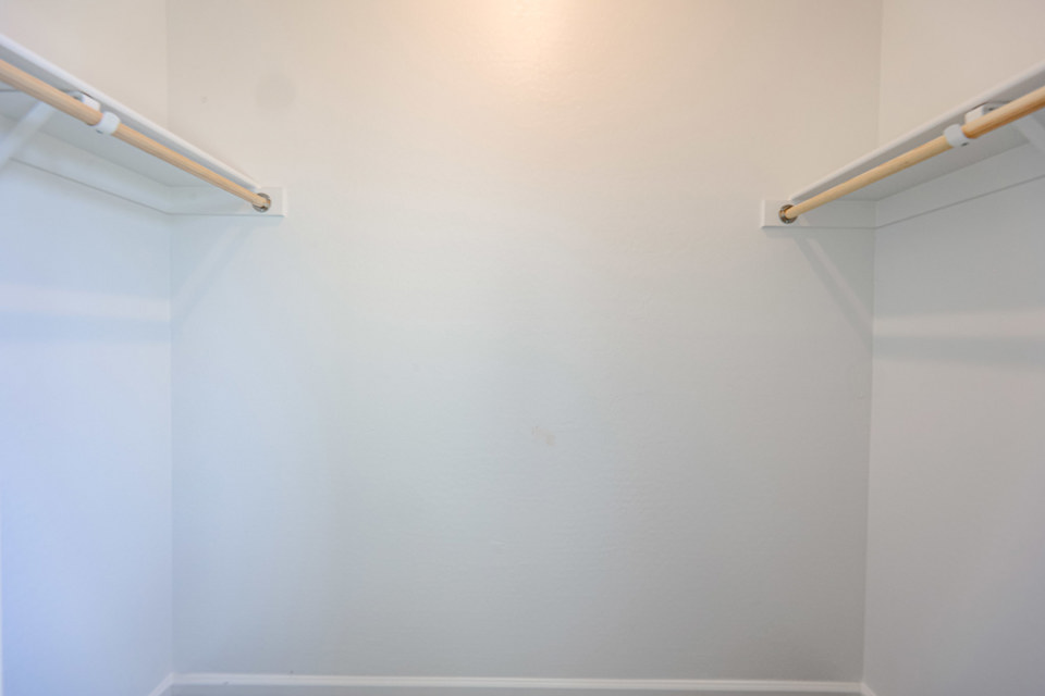 A white wall with a light fixture.