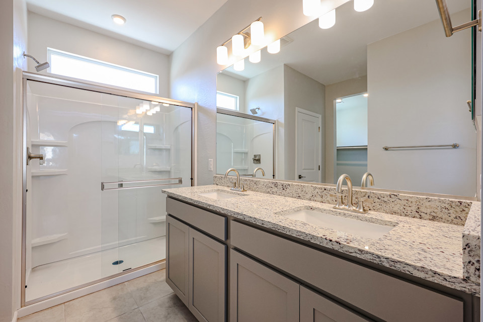 A bathroom with a large mirror.