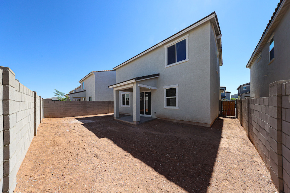 A dirt path between two buildings.