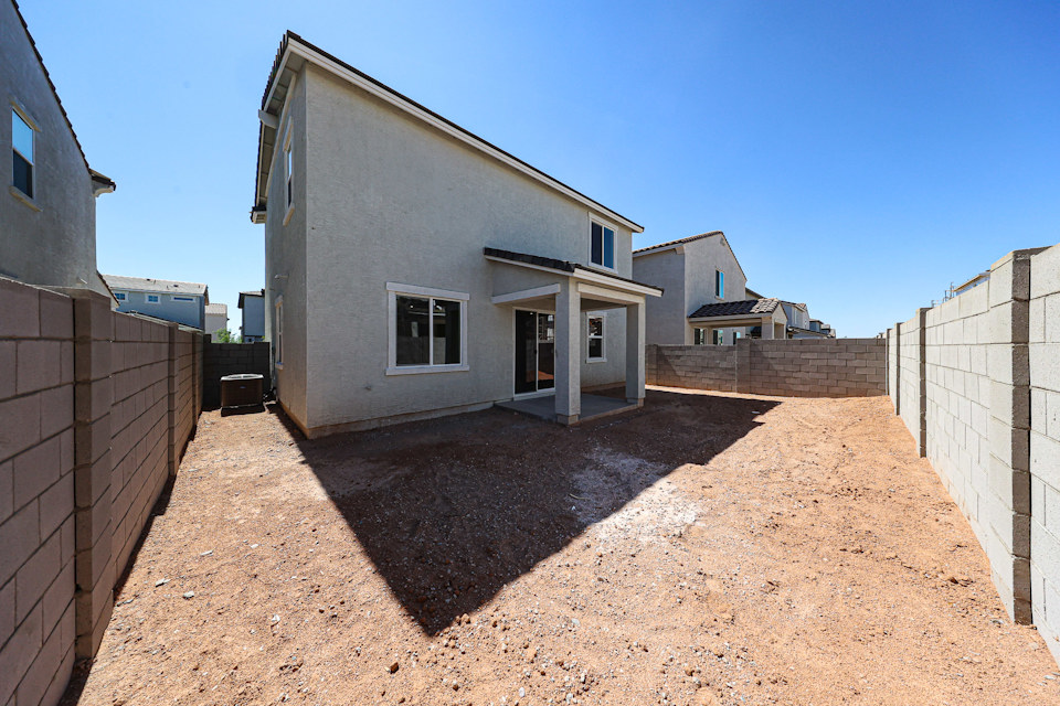 A dirt road between buildings.