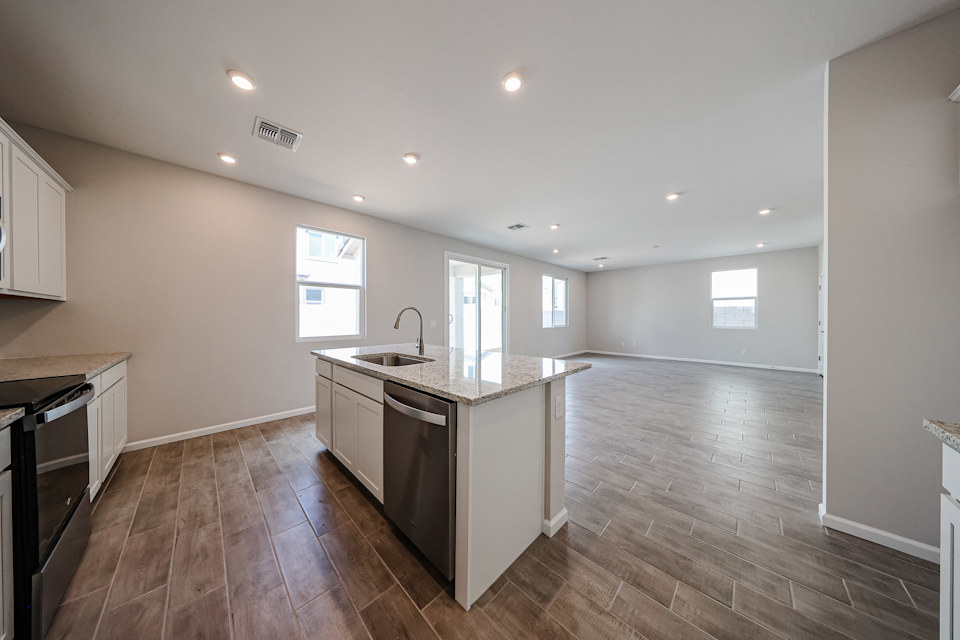 A kitchen with wooden floors.