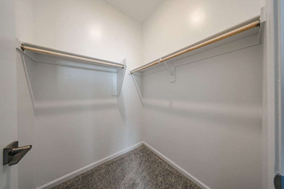 A white wall with a metal bar.