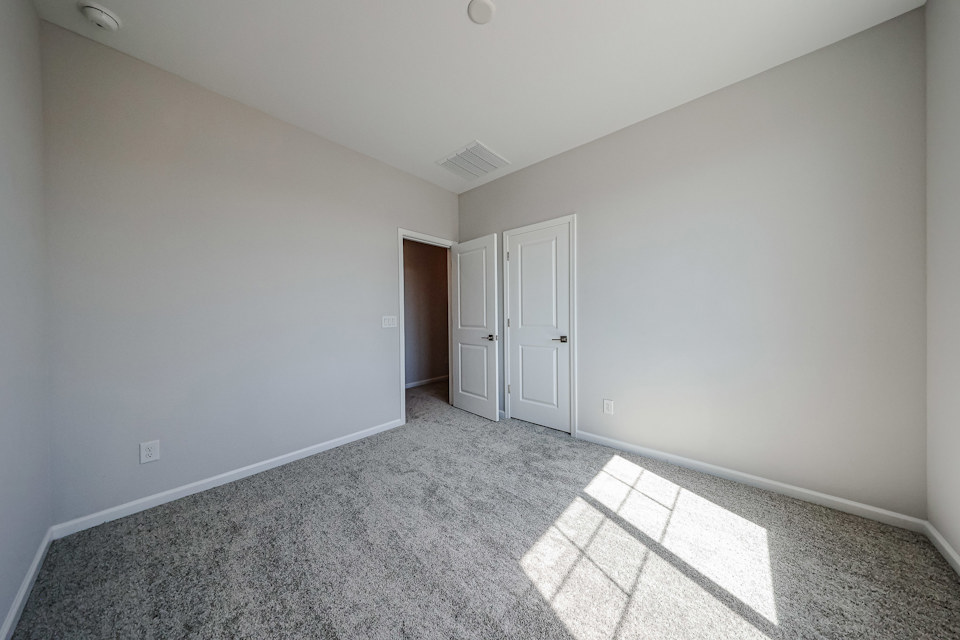 A hallway with white doors.