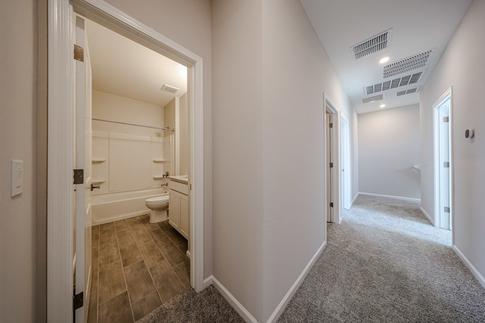 A bathroom with a tub and toilet.