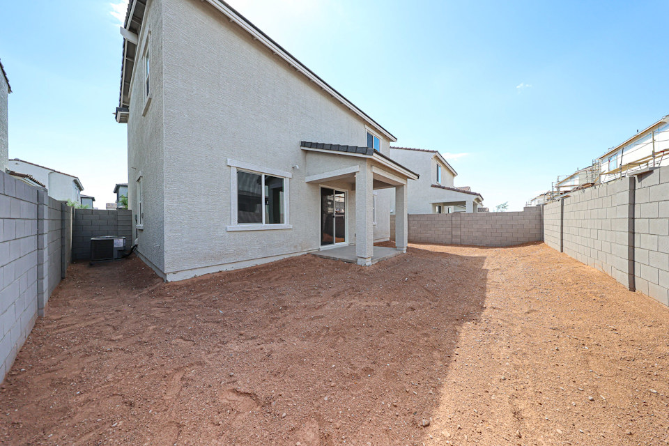 A dirt road between buildings.
