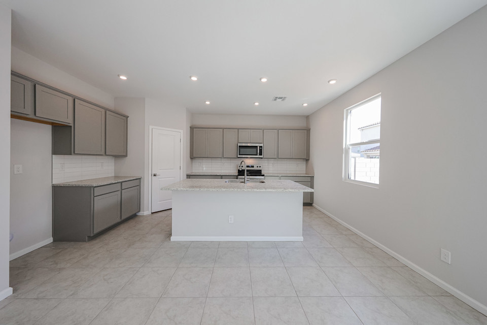A kitchen with white cabinets.
