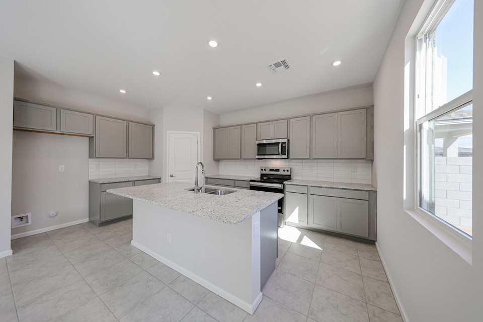 A kitchen with white cabinets.