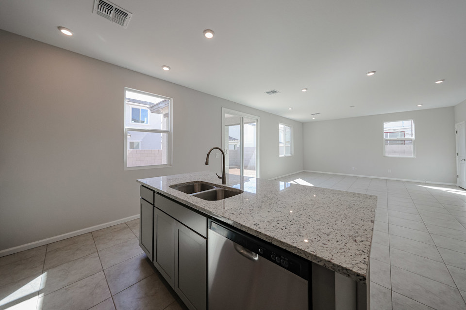 A kitchen with marble counters.