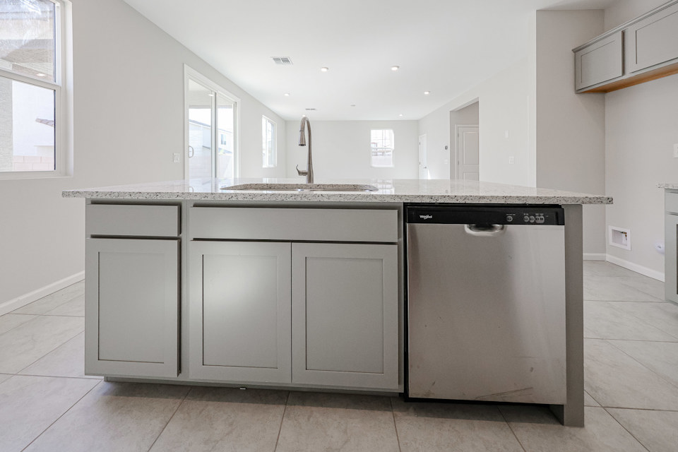 A kitchen with white cabinets.