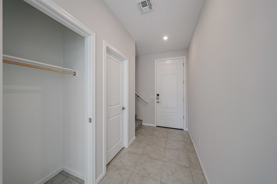 A hallway with white doors.