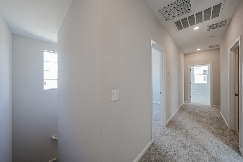 A hallway with white walls.