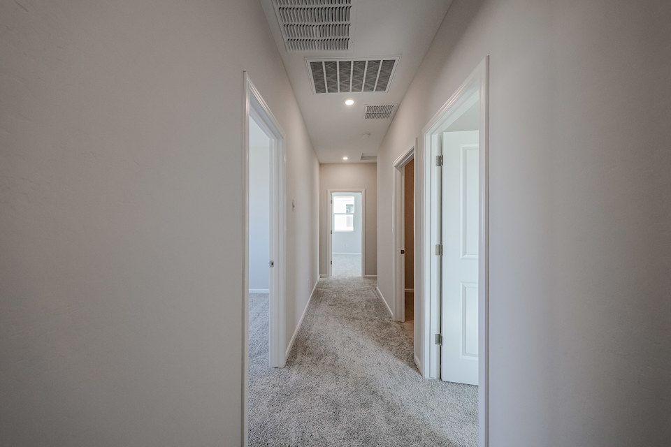 A hallway with white doors.