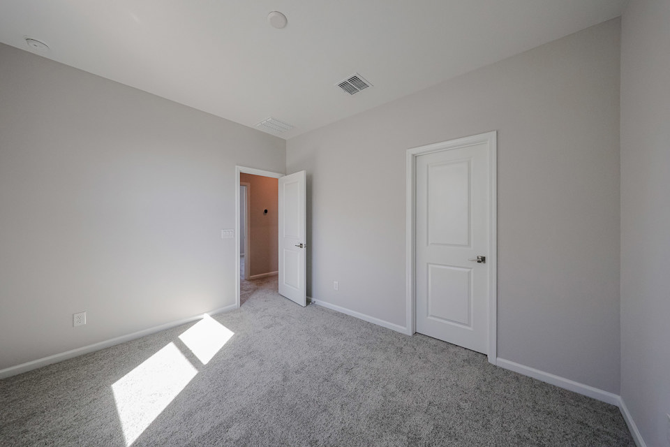 A hallway with white doors.