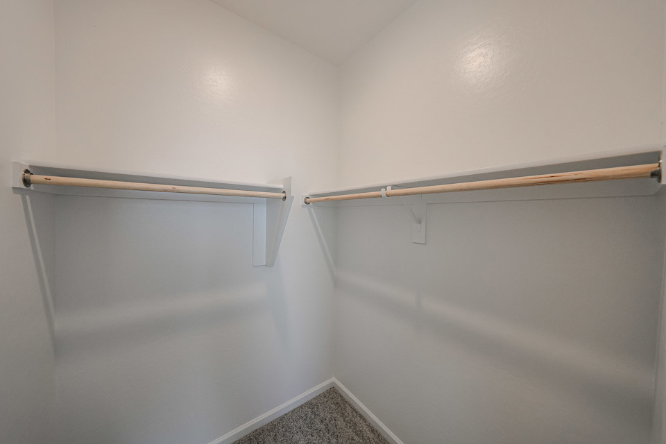 A white wall with a metal bar.