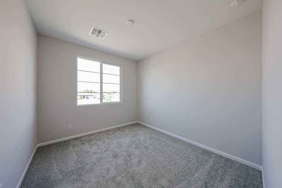 A room with a window and carpet.