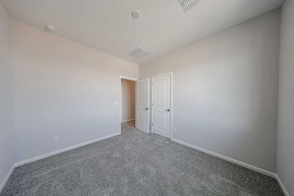 A hallway with white doors.