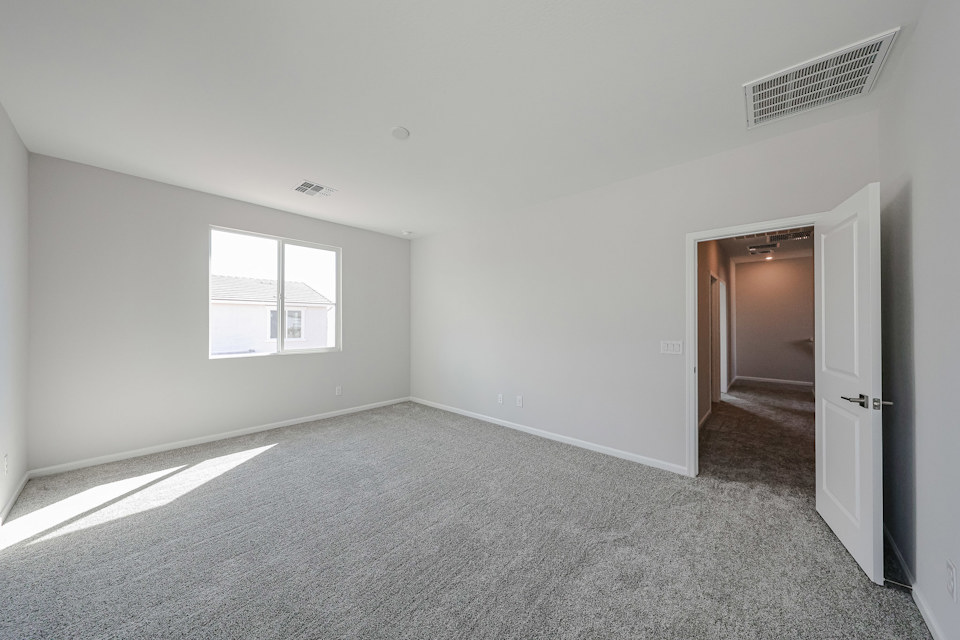 A hallway with a door and a window.