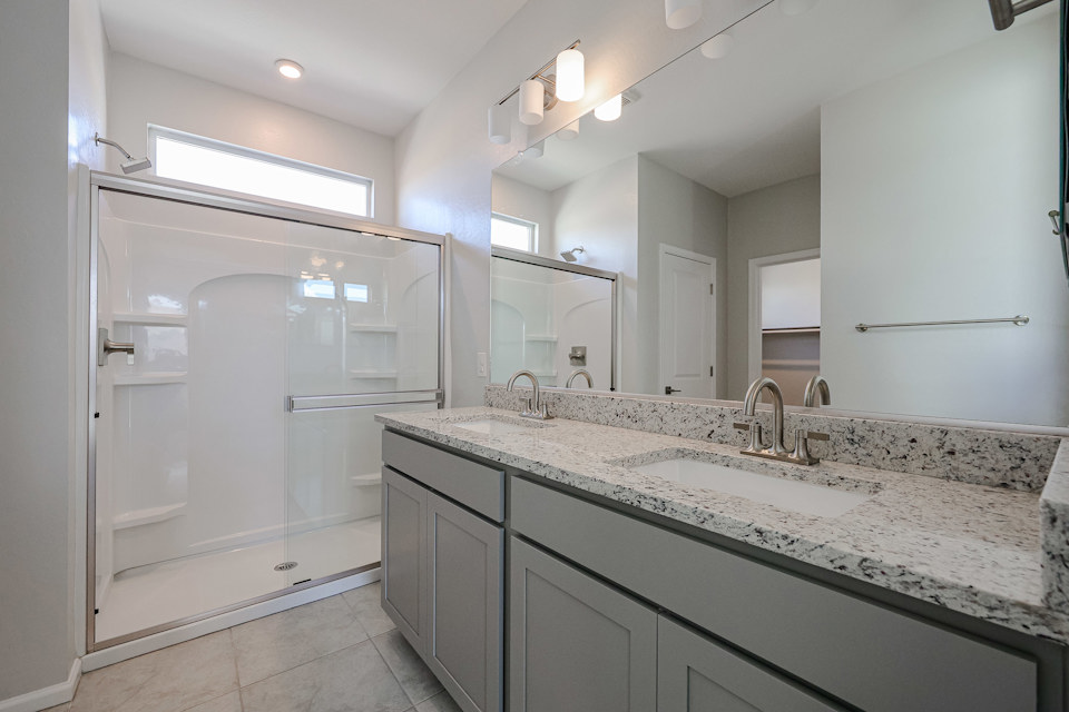 A bathroom with a large mirror.