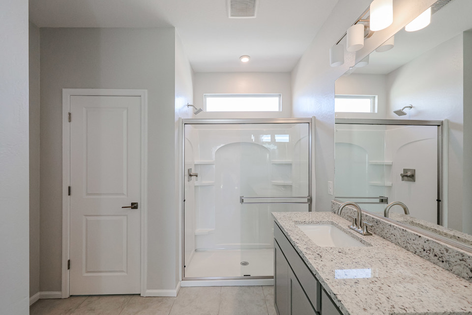 A bathroom with a shower and sink.