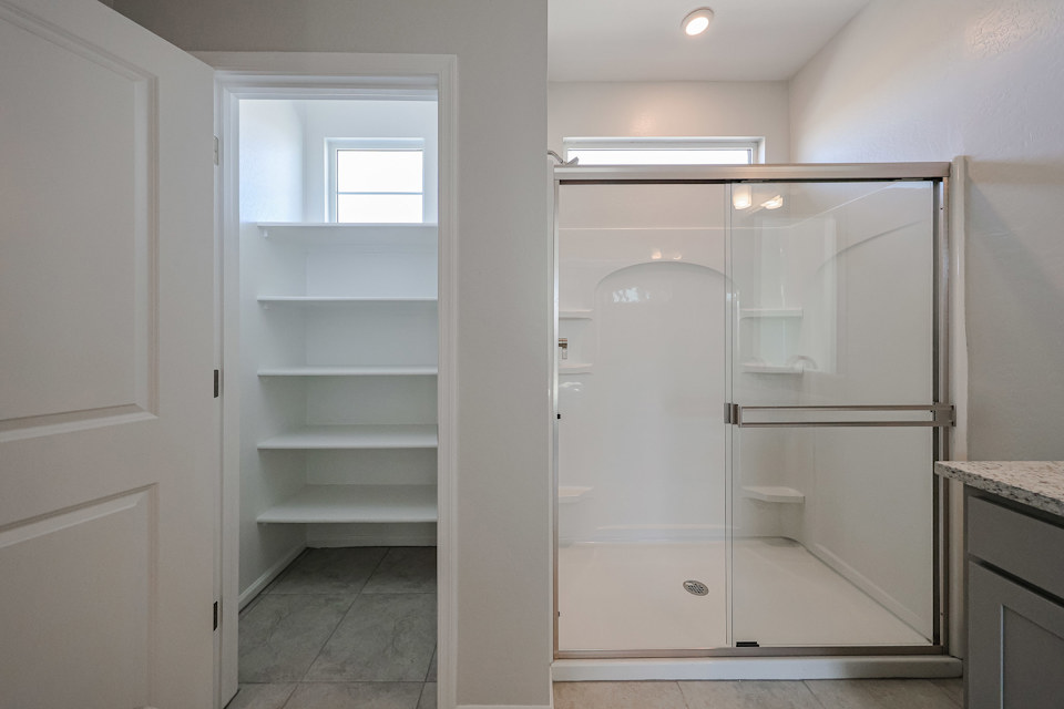 A white closet with a glass door.