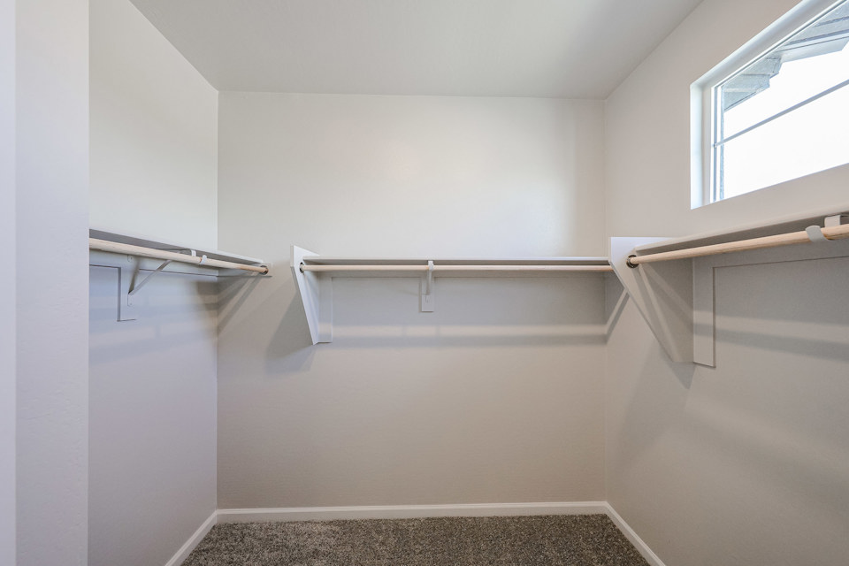A white room with a metal railing.