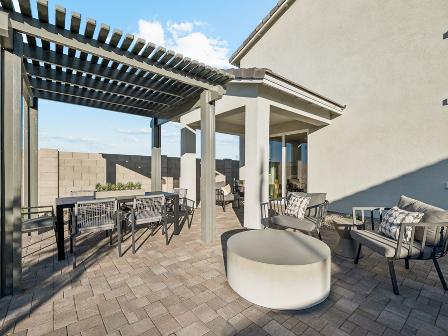 A patio with tables and chairs.