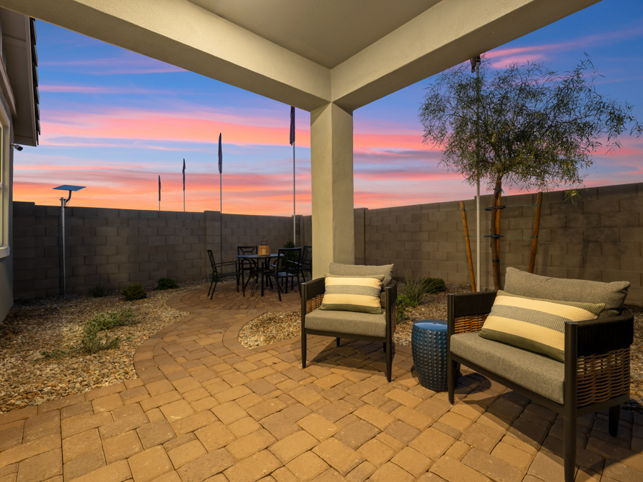A patio with chairs and a table.