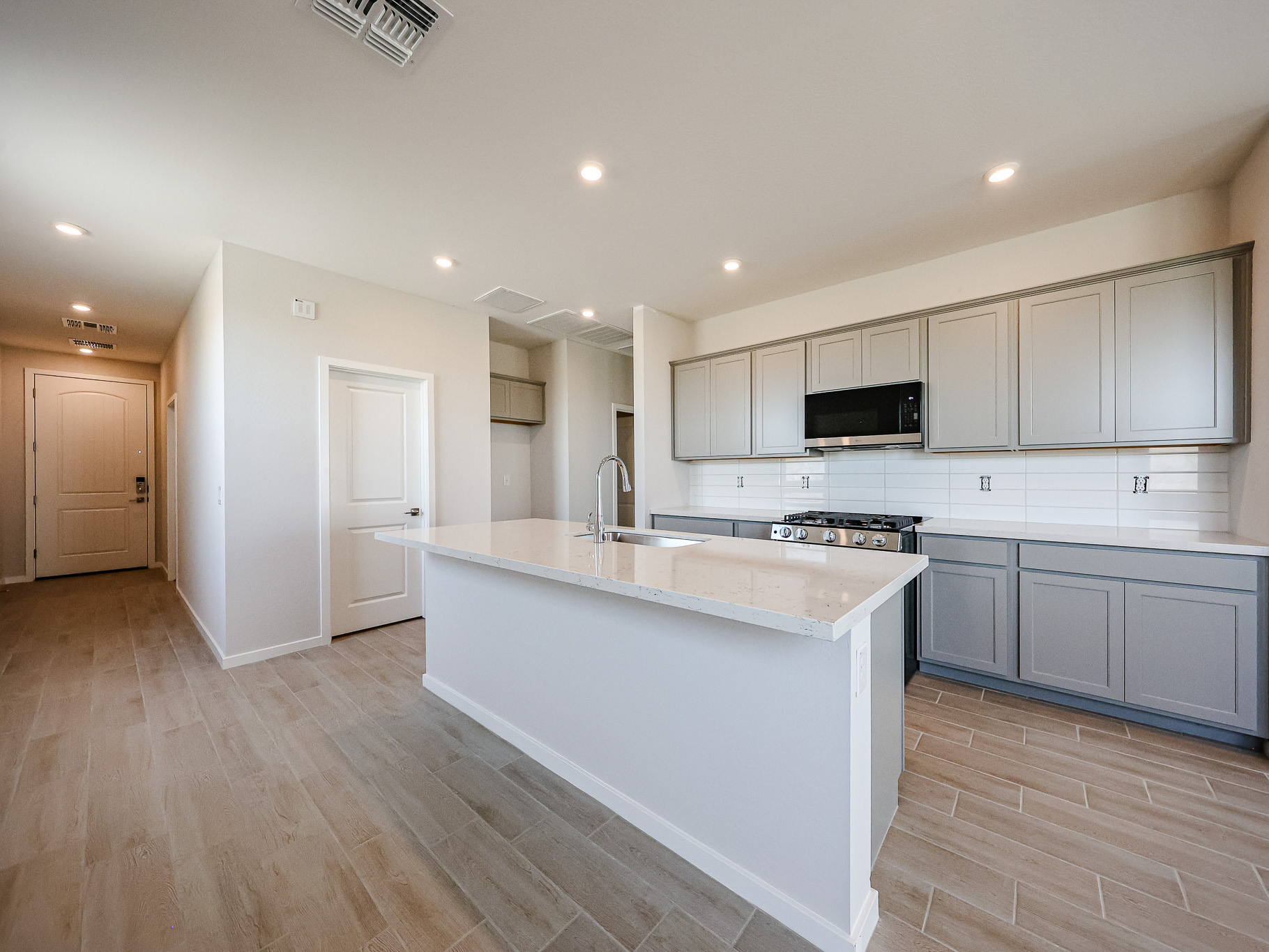 A kitchen with white cabinets.