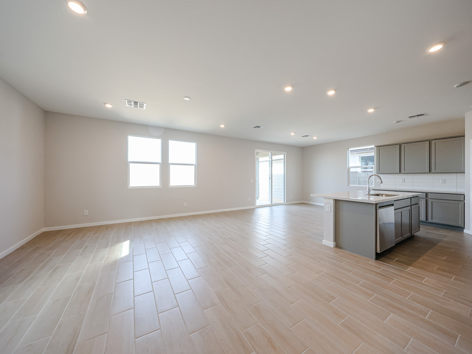 A large kitchen with a wood floor.