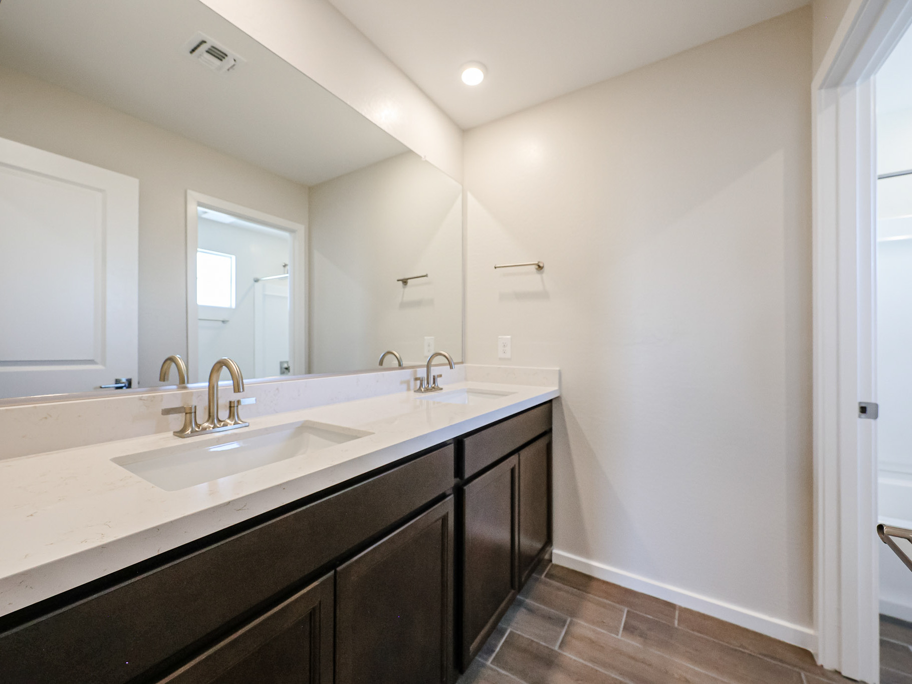 A bathroom with a large mirror.