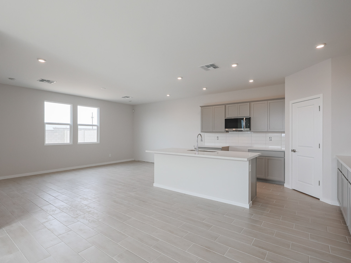 A kitchen with white cabinets.