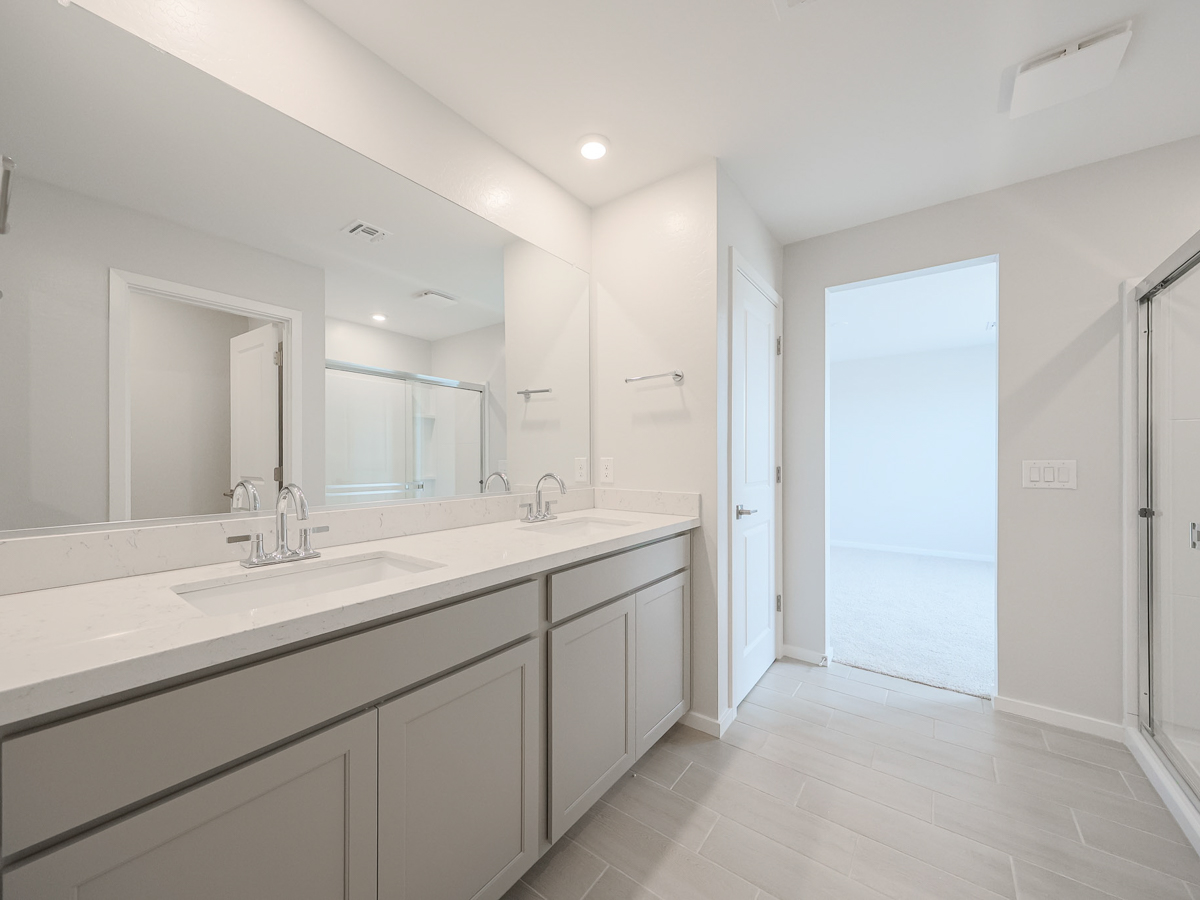 A bathroom with white cabinets.